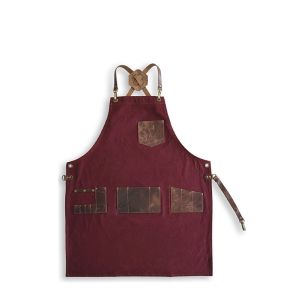 Grembiule professionale in tessuto di tela rossa con tasche in pelle marrone.
